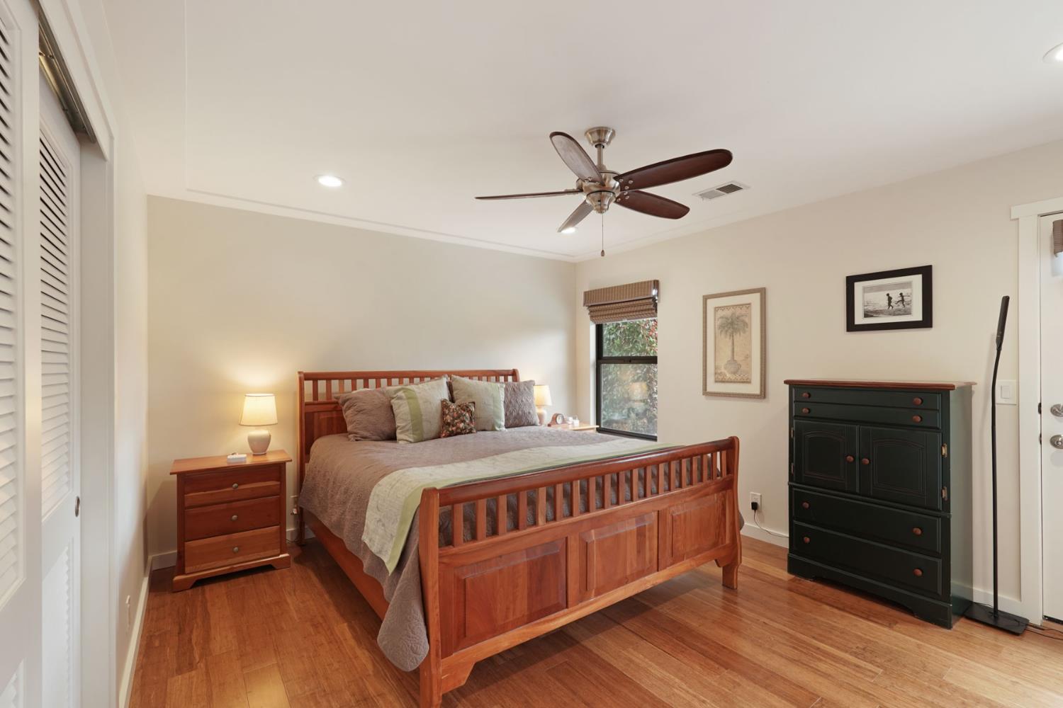 764 Adare Way Galt, CA 95632 - Photo 27 of 59 a bedroom with a bed a chandelier and a dresser