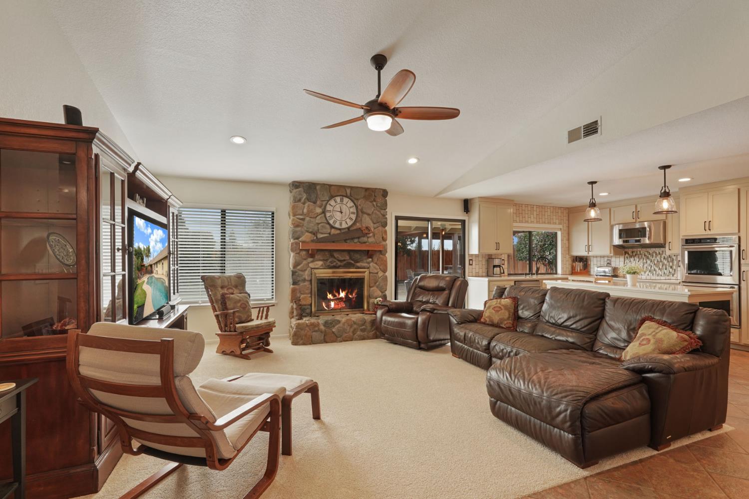 764 Adare Way Galt, CA 95632 - Photo 3 of 59 a living room with furniture a fireplace and a large window