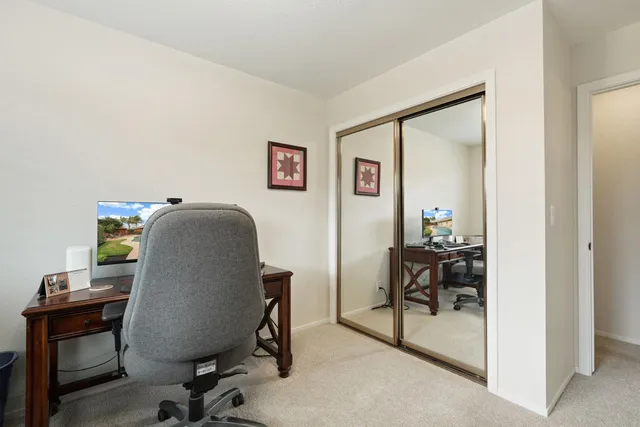a front view of a house with swimming pool having outdoor seating