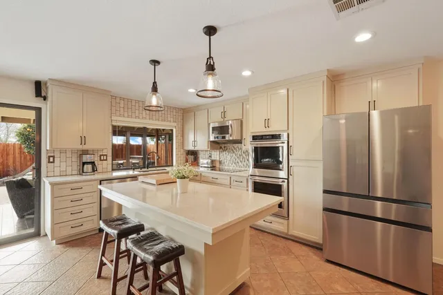 a kitchen with stainless steel appliances white cabinets and a granite counter tops