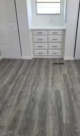 a view of walk in closet with empty racks