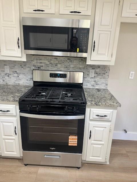 401 Willow Way Wylie, TX 75098 - Photo 7 of 19 a stove top oven sitting inside of a kitchen