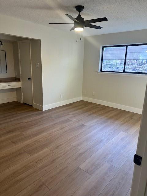 401 Willow Way Wylie, TX 75098 - Photo 10 of 19 an empty room with wooden floor chandelier fan and windows
