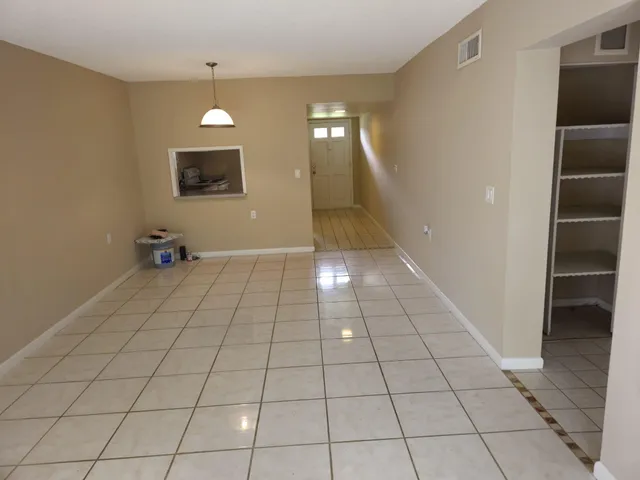a view of an empty room and stairs