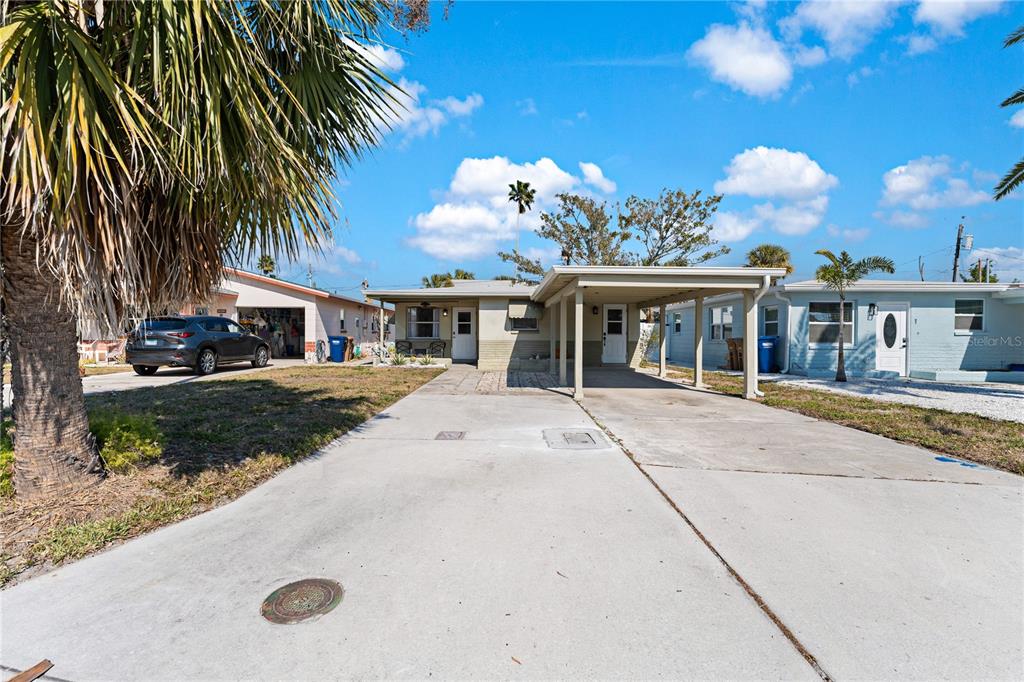 13313 2nd Street East Madeira Beach, FL 33708 - Photo 22 of 36 a view of a house with a swimming pool