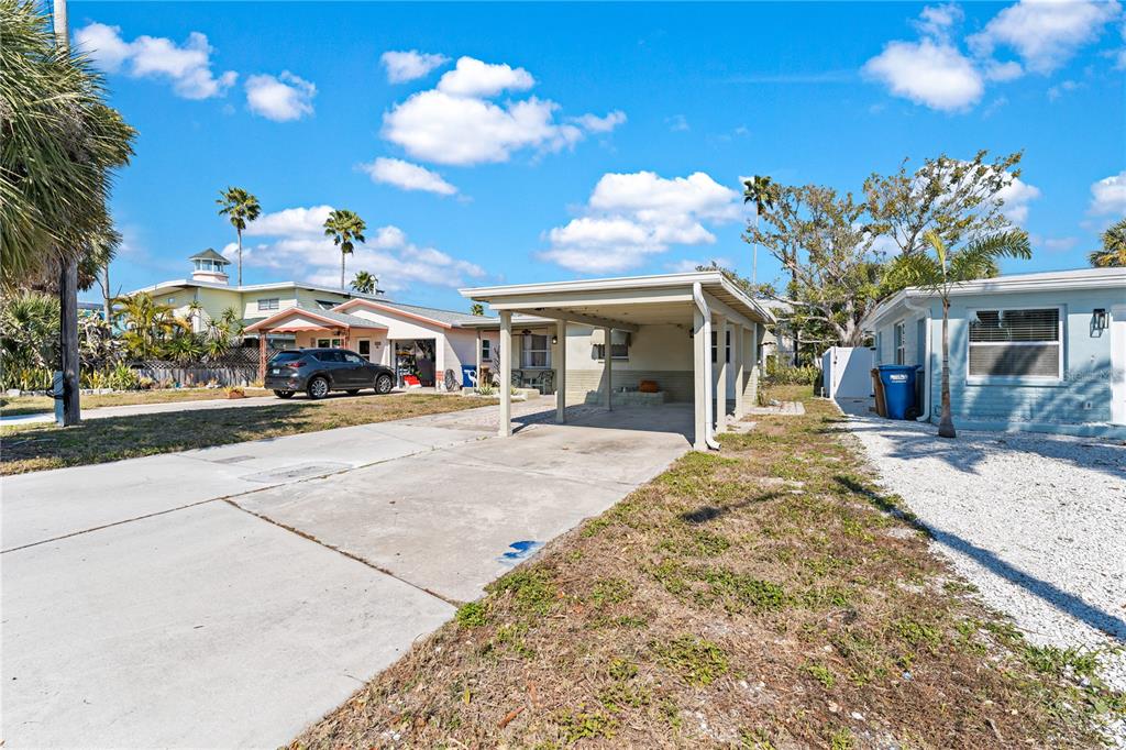 13313 2nd Street East Madeira Beach, FL 33708 - Photo 26 of 36 a bedroom with a bed and a chandelier