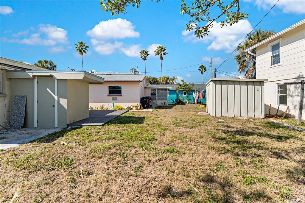 13313 2nd Street East Madeira Beach, FL 33708 - Photo 32 of 36 a bed room with a yard and a chair