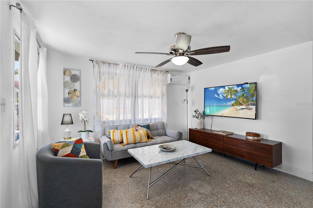 13313 2nd Street East Madeira Beach, FL 33708 - Photo 4 of 36 a living room with furniture and a flat screen tv