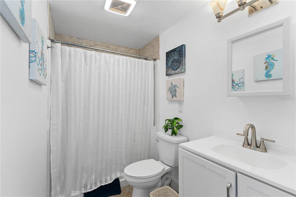 13313 2nd Street East Madeira Beach, FL 33708 - Photo 6 of 36 a bathroom with a sink a toilet and a mirror