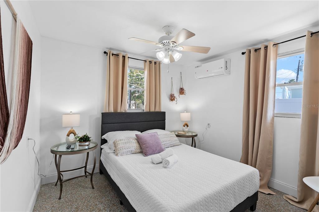 13313 2nd Street East Madeira Beach, FL 33708 - Photo 7 of 36 a bedroom with a bed and a chandelier