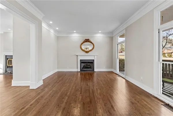 a view of a room with wooden floor