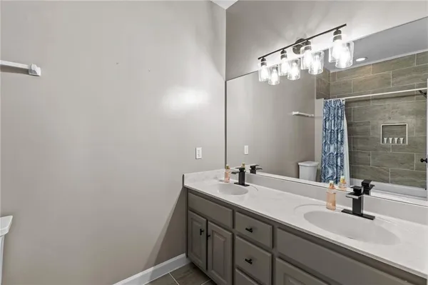 a kitchen with stainless steel appliances granite countertop a white cabinets a sink dishwasher and a stove with wooden floor