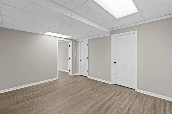 an empty room with wooden floor and a window