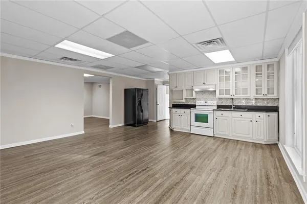 a living room with furniture a flat screen tv and a large window