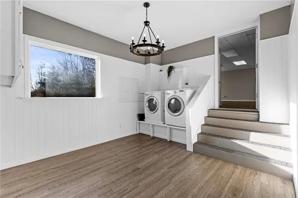 a view of entryway livingroom and hall with wooden floor