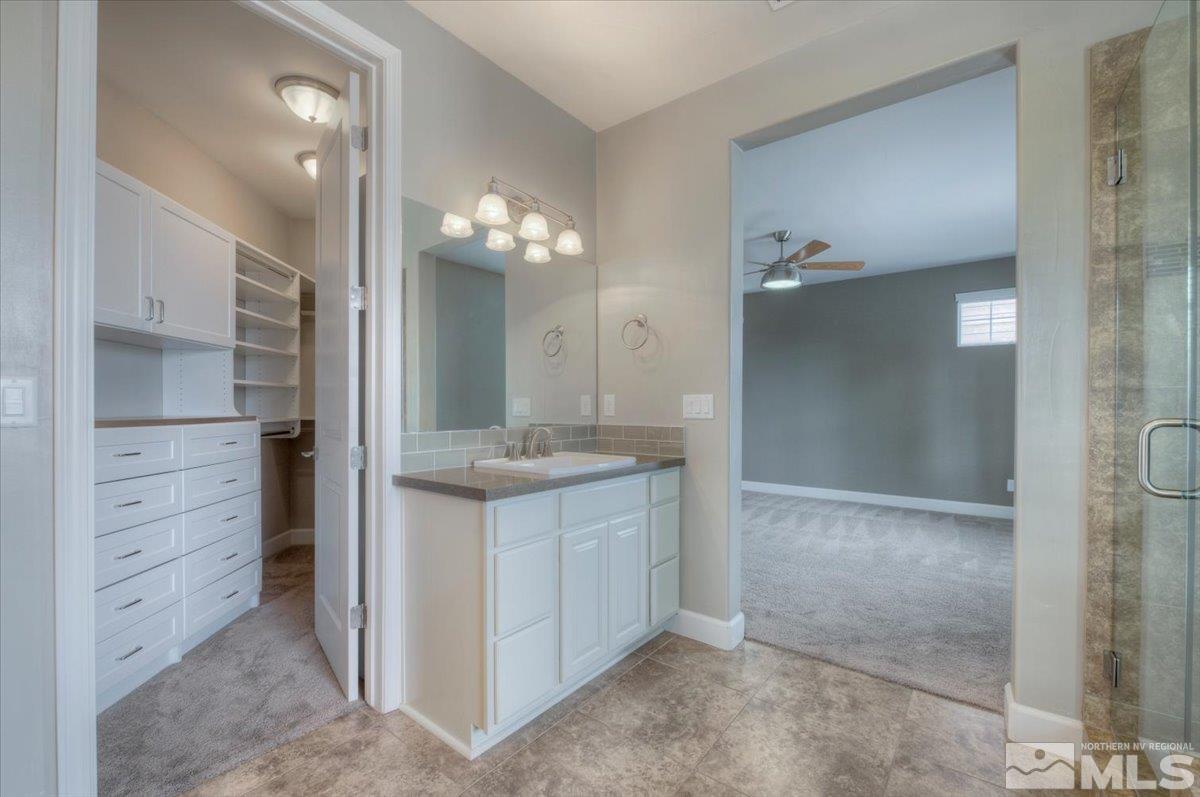 300 Mt Rose Street Reno, NV 89509 - Photo 11 of 26 a bathroom with a granite countertop sink a mirror and a shower