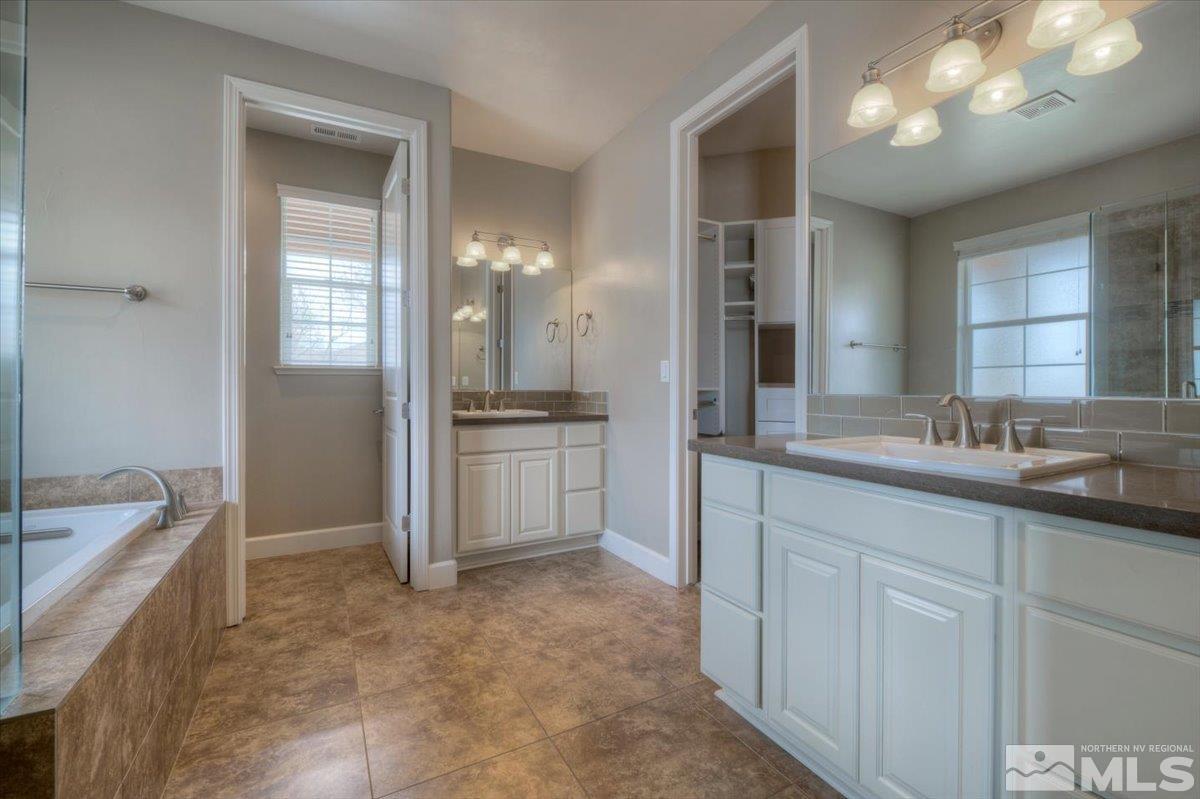 300 Mt Rose Street Reno, NV 89509 - Photo 13 of 26 a bathroom with a tub sink and mirror