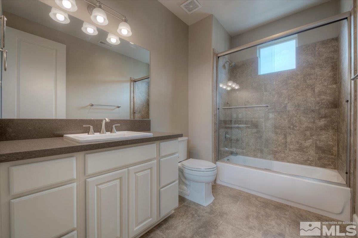300 Mt Rose Street Reno, NV 89509 - Photo 19 of 26 a bathroom with a double vanity sink a toilet and a bathtub