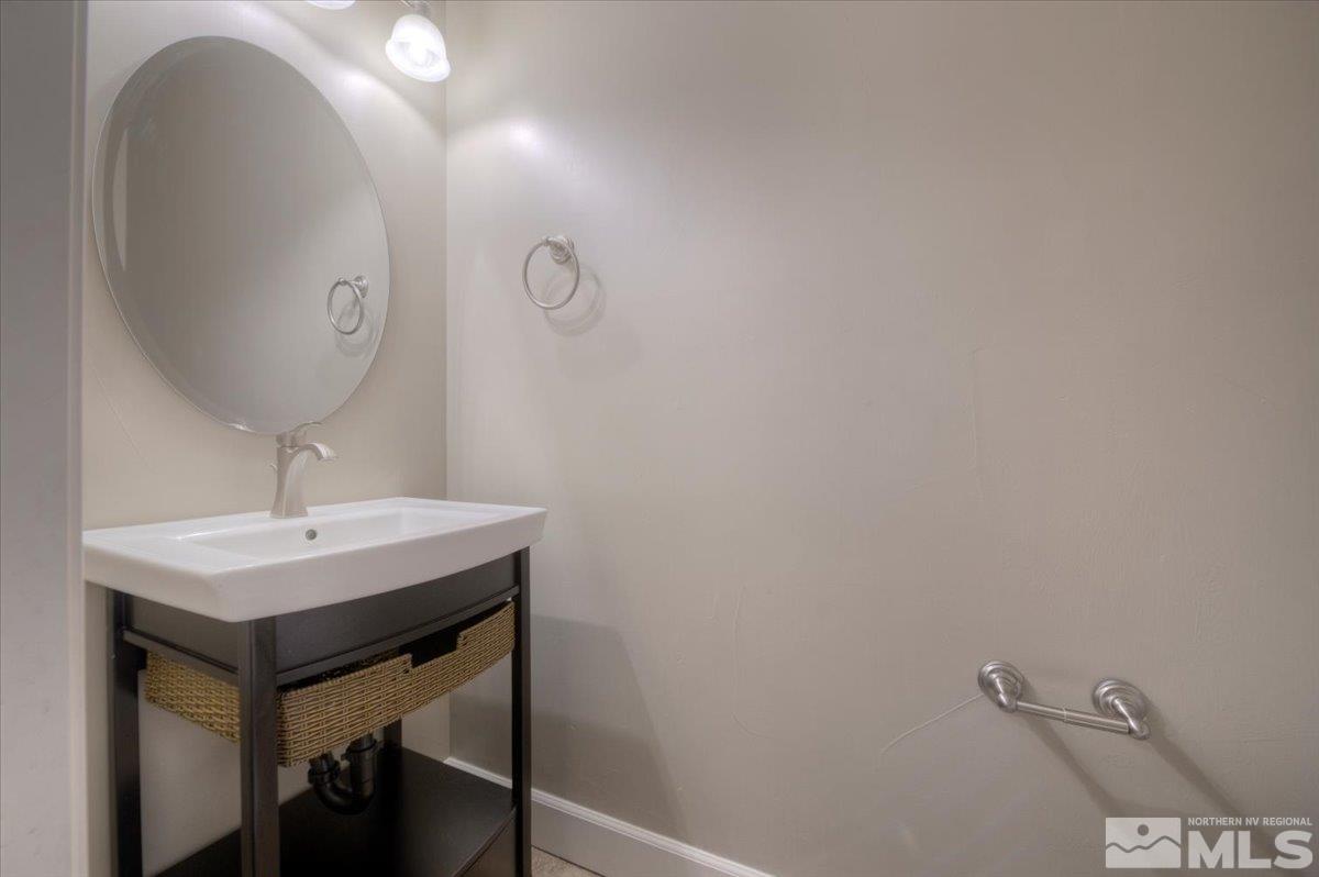 300 Mt Rose Street Reno, NV 89509 - Photo 20 of 26 a bathroom with a sink a mirror and vanity