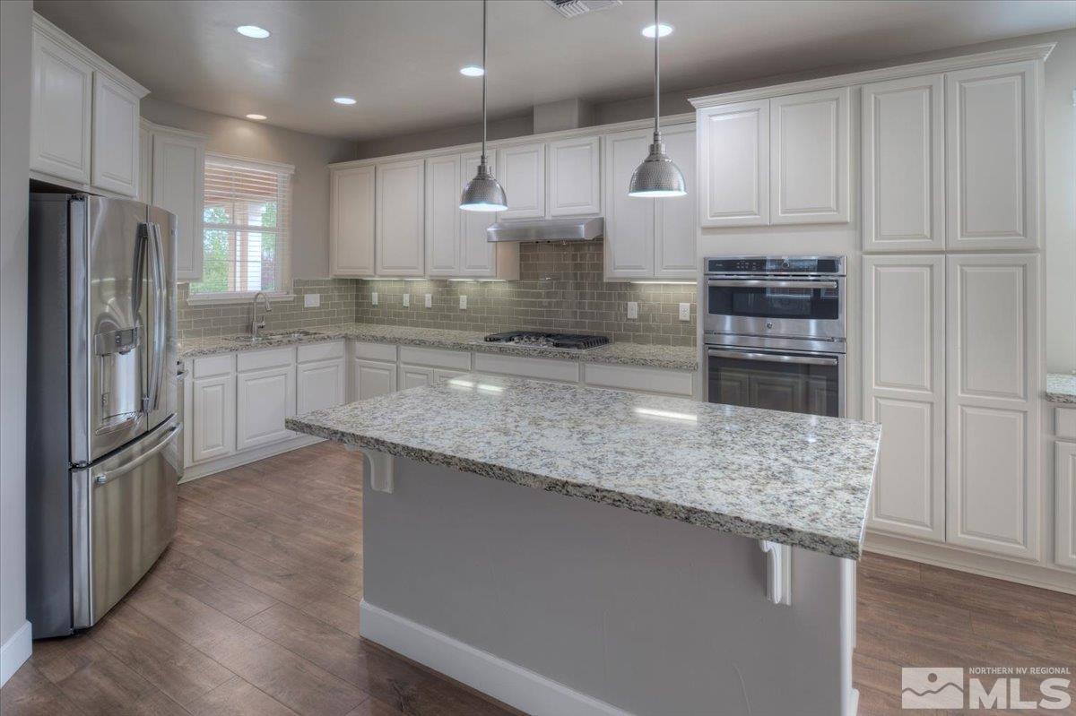300 Mt Rose Street Reno, NV 89509 - Photo 7 of 26 a kitchen with stainless steel appliances granite countertop a refrigerator a stove and a sink