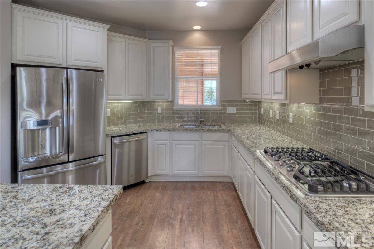300 Mt Rose Street Reno, NV 89509 - Photo 8 of 26 a kitchen with granite countertop a sink stove and refrigerator