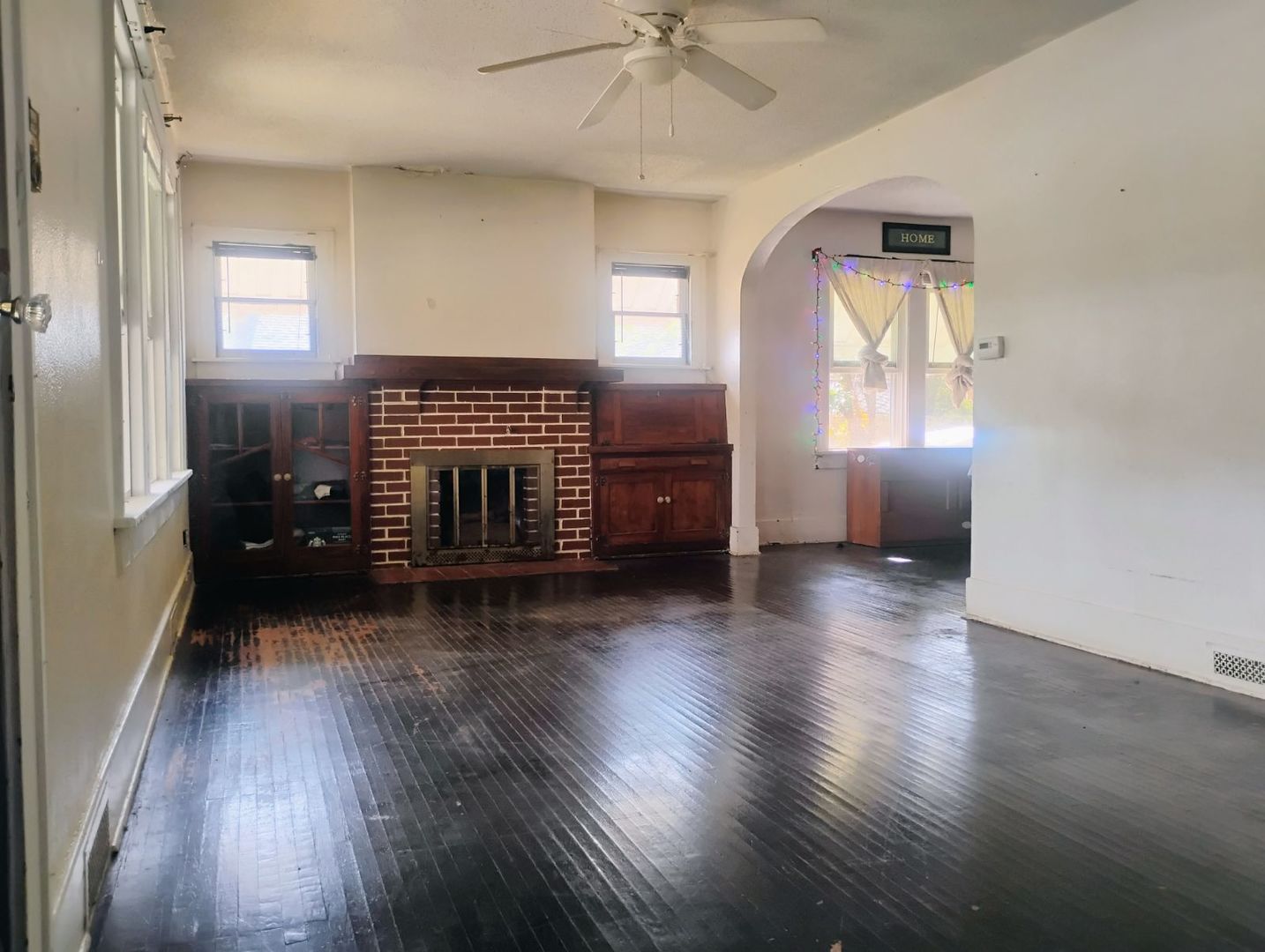 729 South 22nd Street Decatur, IL 62521 - Photo 10 of 22 an empty room with wooden floor fireplace and windows