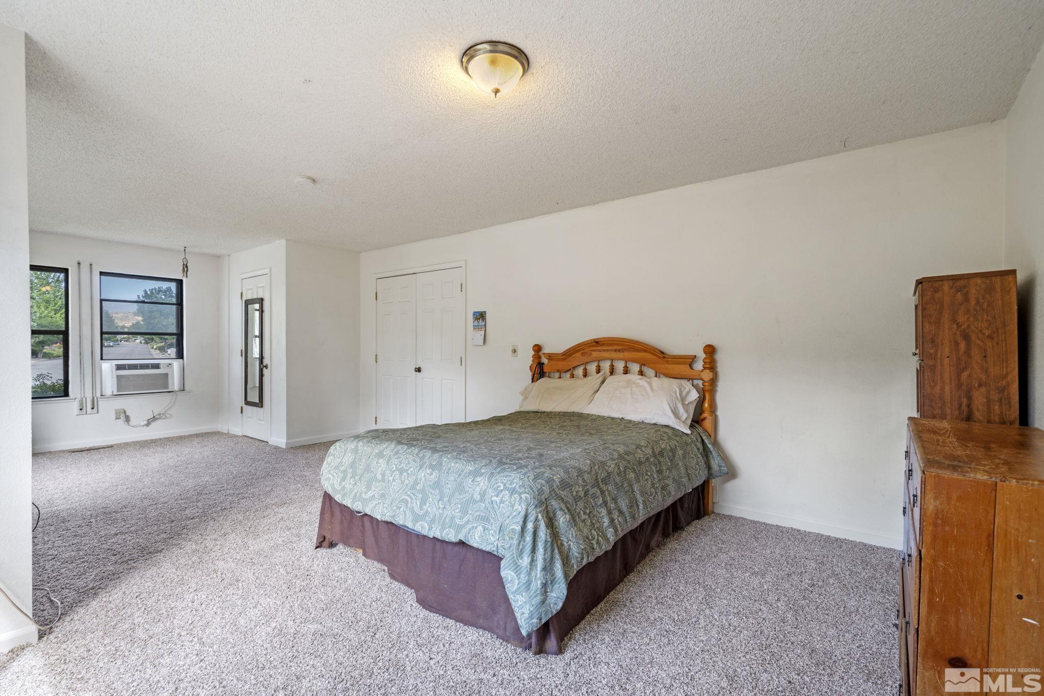 95 Cliff View Drive Reno, NV 89523 - Photo 28 of 39 a spacious bedroom with a bed and a table in it
