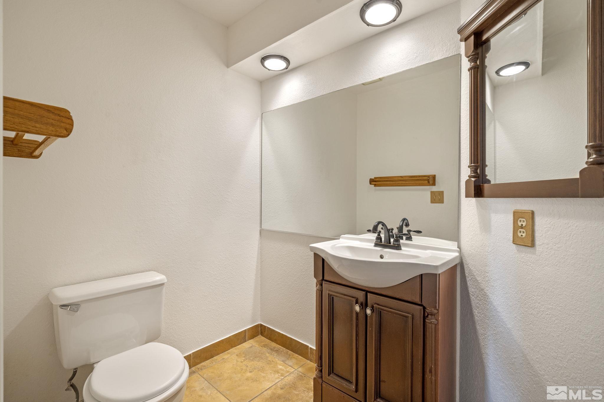 95 Cliff View Drive Reno, NV 89523 - Photo 29 of 39 a bathroom with a sink toilet and mirror