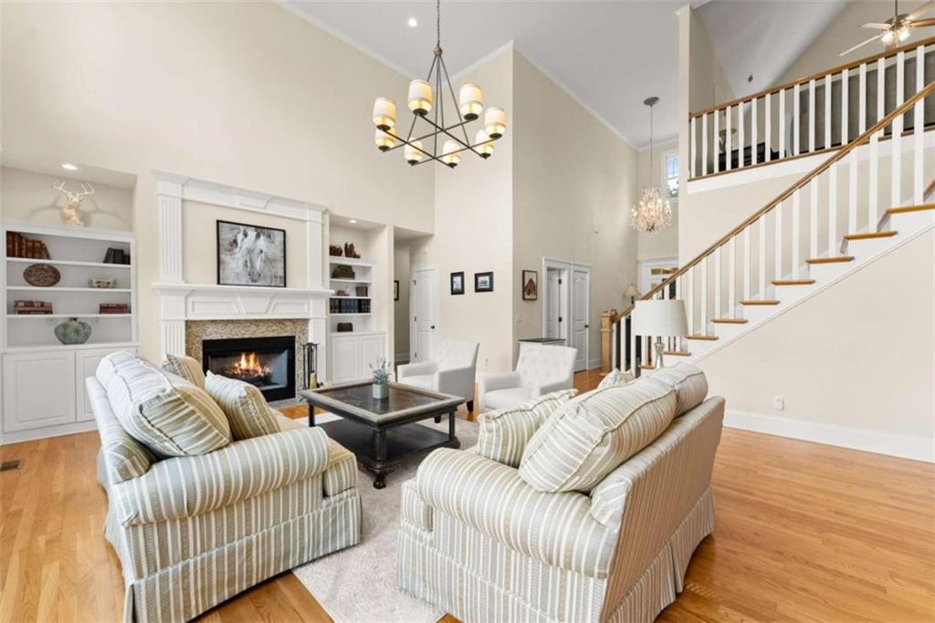 526 Orchard Drive Clarkesville, GA 30523 - Photo 24 of 81 a living room with furniture a chandelier and a fireplace