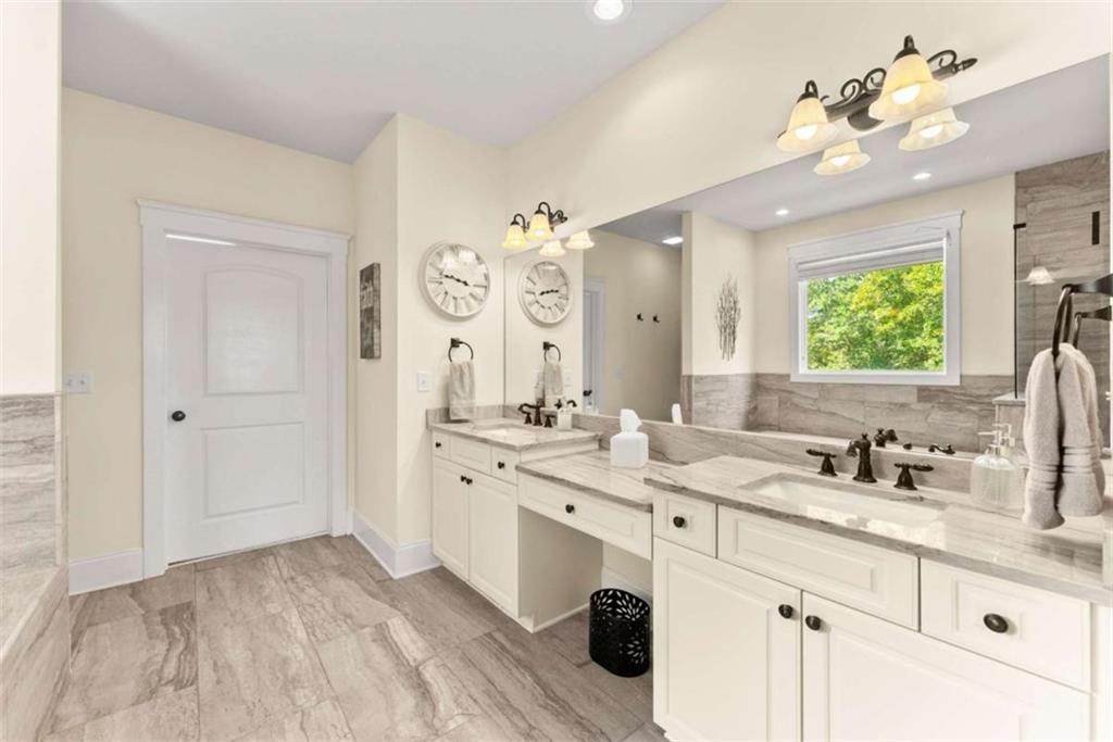 526 Orchard Drive Clarkesville, GA 30523 - Photo 33 of 81 a spacious bathroom with a double vanity sink mirror and chandelier