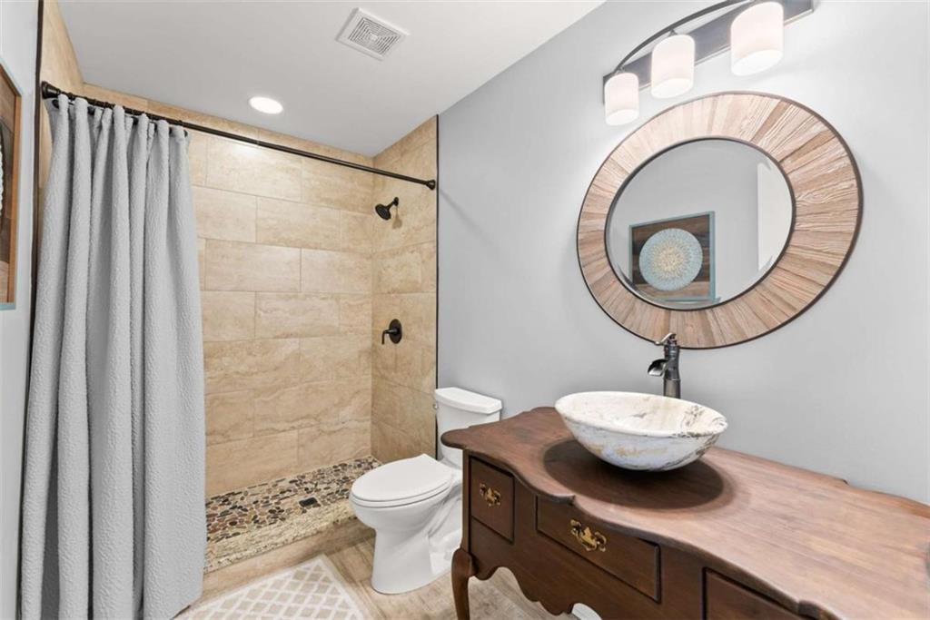 526 Orchard Drive Clarkesville, GA 30523 - Photo 46 of 81 a bathroom with a sink a toilet and a mirror