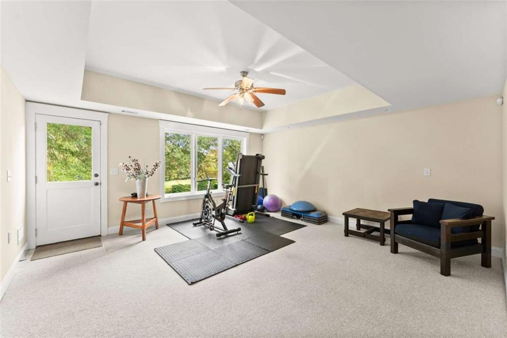 526 Orchard Drive Clarkesville, GA 30523 - Photo 53 of 81 a living room with furniture gym equipment and a large window