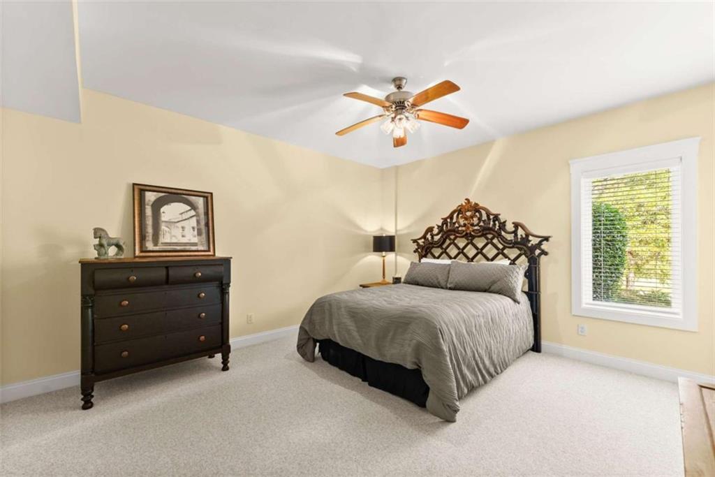 526 Orchard Drive Clarkesville, GA 30523 - Photo 56 of 81 a bedroom with a bed and a chandelier