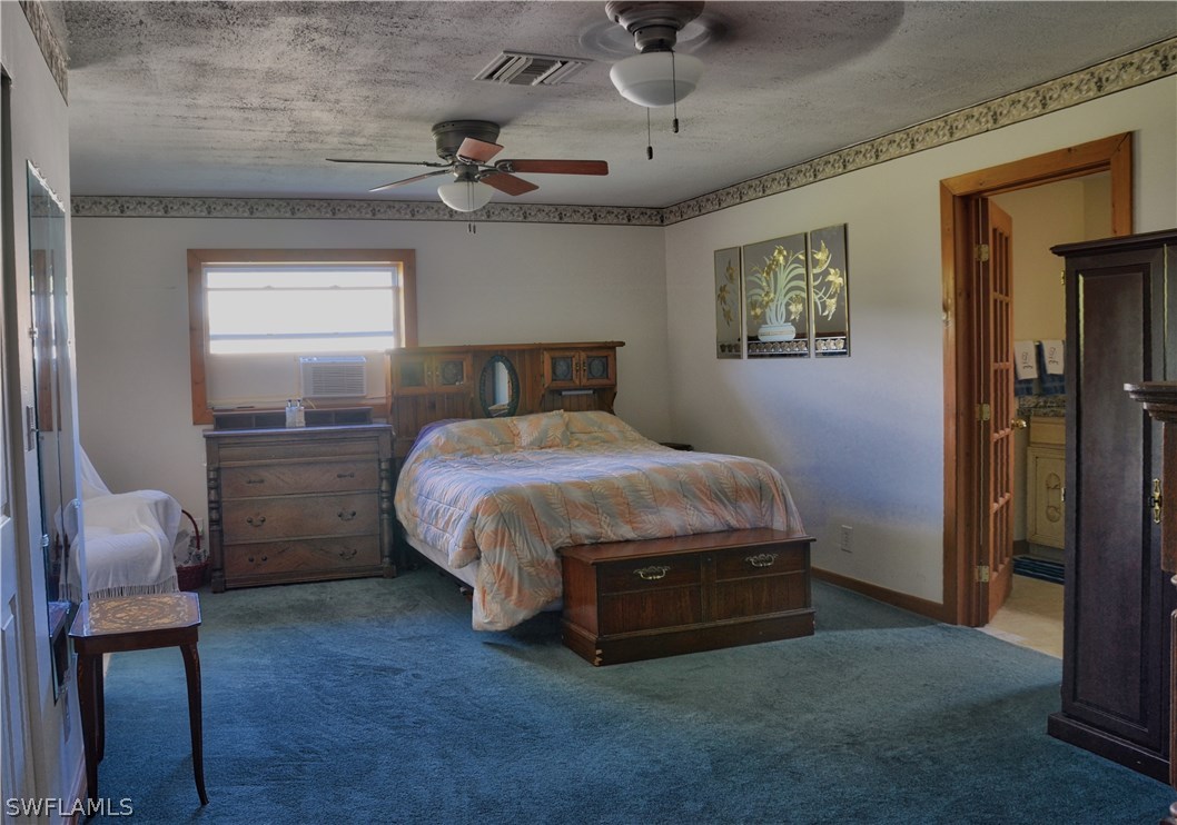 23081 North River Road Alva, FL 33920 - Photo 11 of 25 a bedroom with a bed and a chair