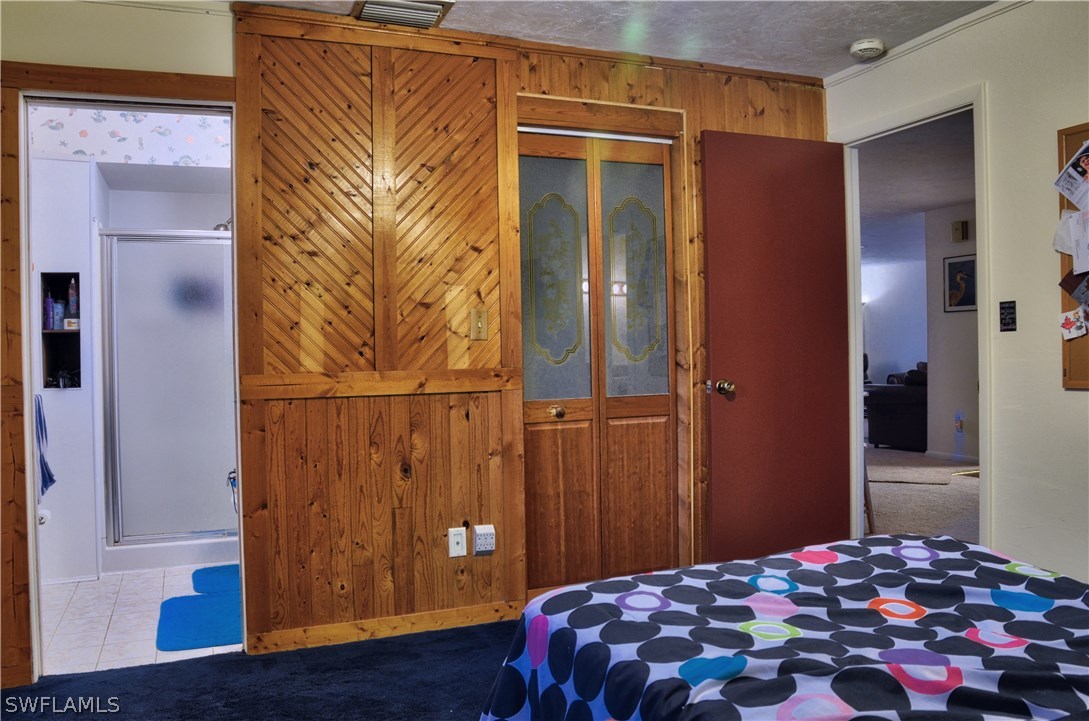 23081 North River Road Alva, FL 33920 - Photo 15 of 25 a bedroom with a bed and wooden floor