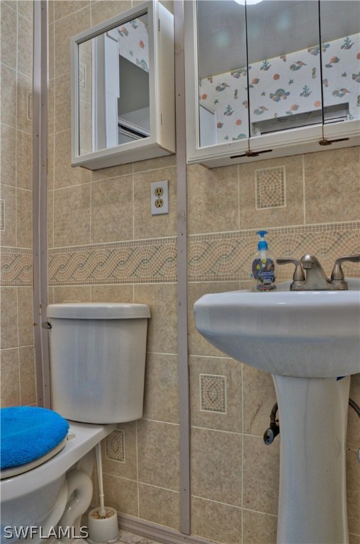 23081 North River Road Alva, FL 33920 - Photo 16 of 25 a bathroom with a toilet and a sink