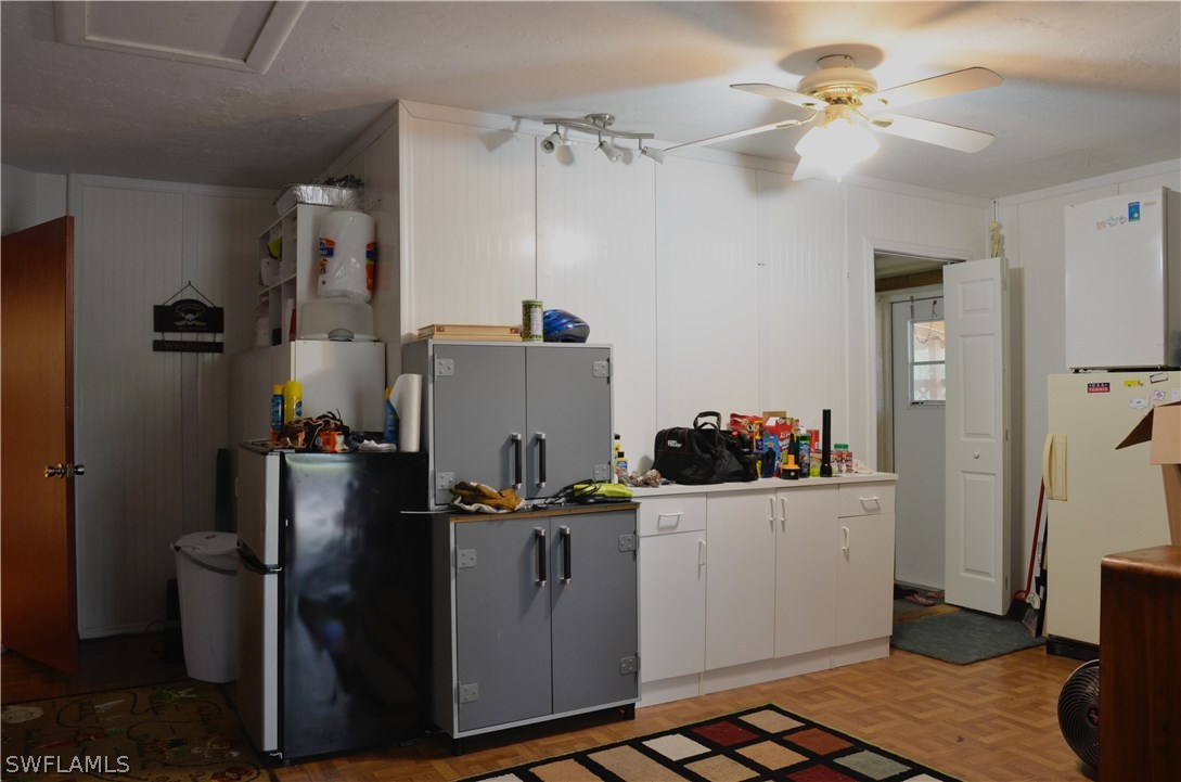 23081 North River Road Alva, FL 33920 - Photo 22 of 25 a room with refrigerator and cabinets