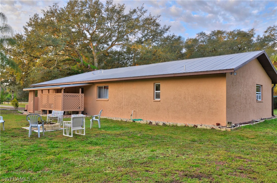 23081 North River Road Alva, FL 33920 - Photo 25 of 25 a backyard of a house with table and chairs
