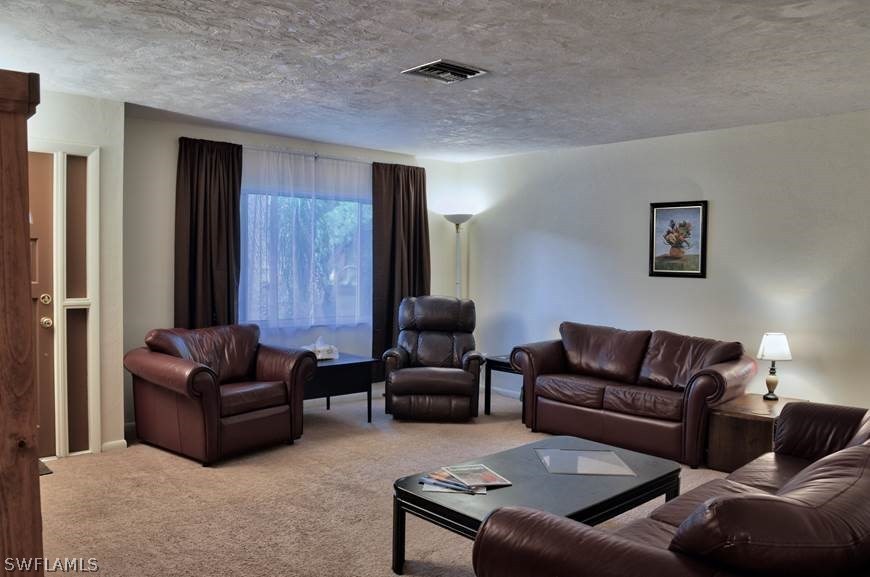 23081 North River Road Alva, FL 33920 - Photo 3 of 25 a living room with furniture and a couch