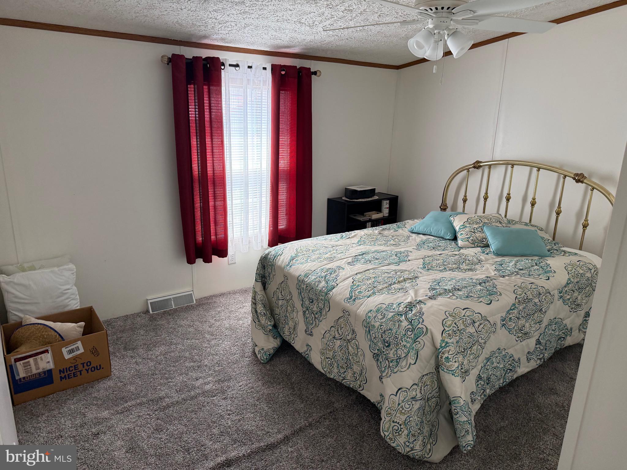 821 Rum Bridge Branch Road Seaford, DE 19973 - Photo 9 of 15 a bed sitting in a bedroom next to a window