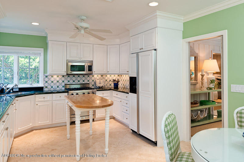 304 Plantation Road Palm Beach, FL 33480 - Photo 6 of 10 a kitchen with stainless steel appliances a sink a stove a refrigerator cabinets and a dining table