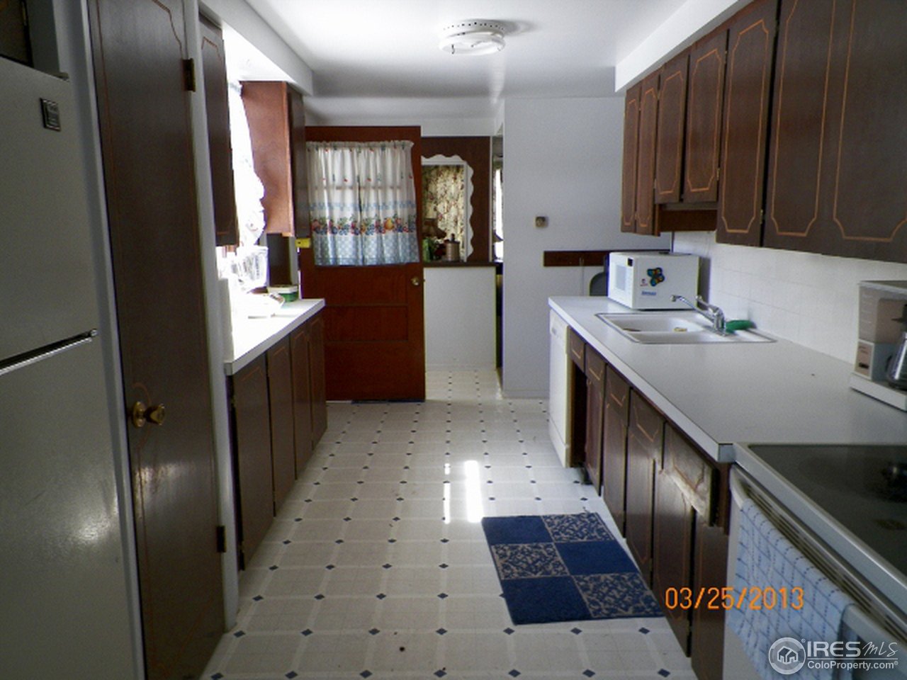 411 Ray Street Brush, CO 80723 - Photo 5 of 6 a kitchen with stainless steel appliances granite countertop a refrigerator and a stove top oven