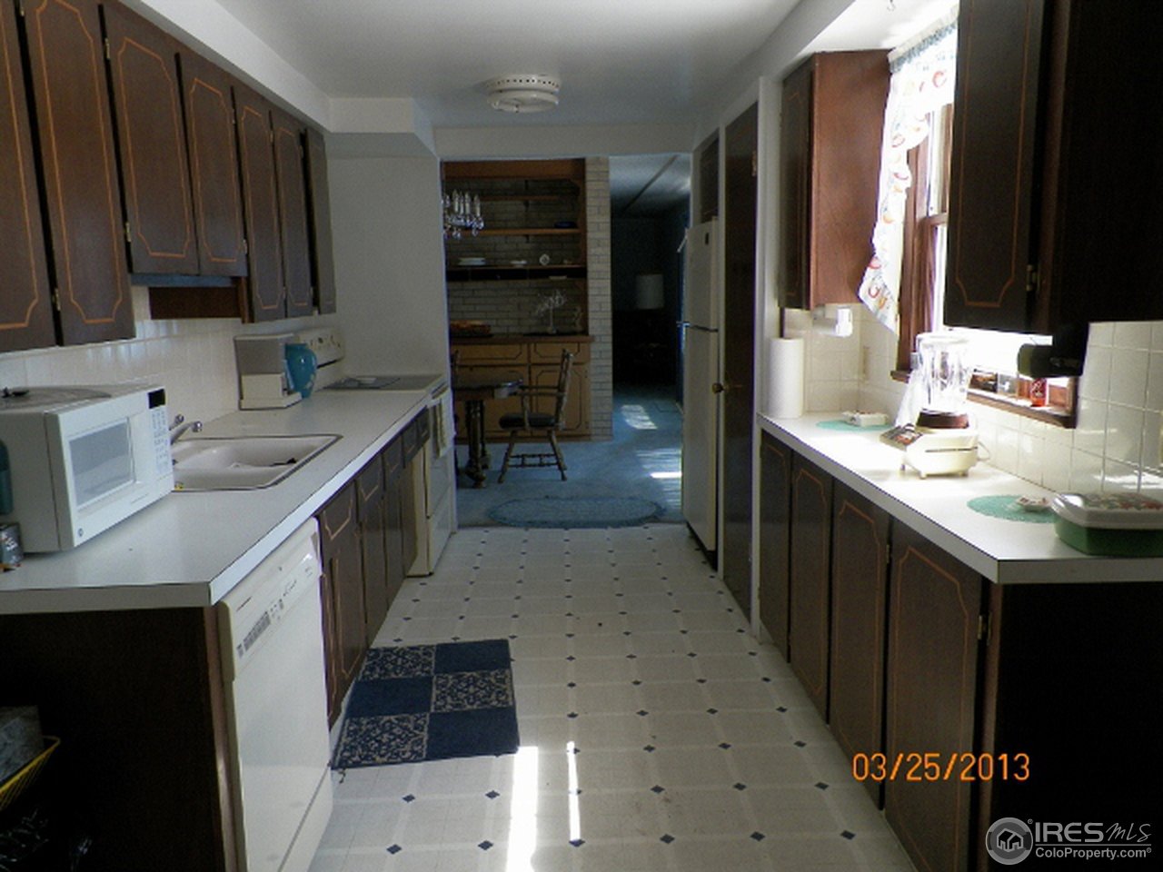 411 Ray Street Brush, CO 80723 - Photo 6 of 6 a kitchen with a sink stove and cabinets