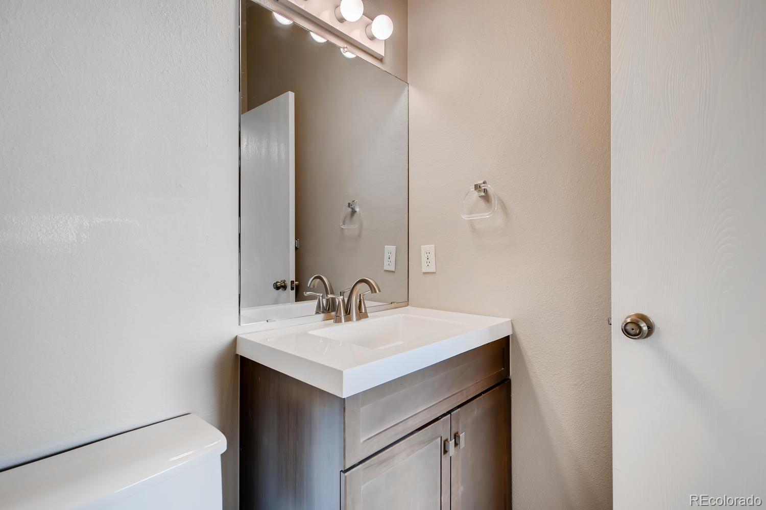 862 Summer Drive Highlands Ranch, CO 80126 - Photo 14 of 21 a bathroom with a sink and a mirror
