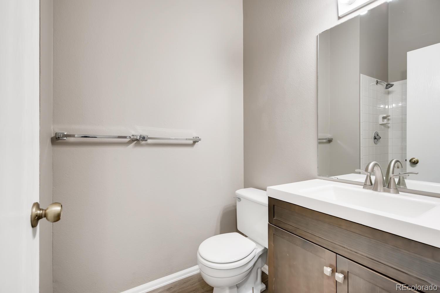 862 Summer Drive Highlands Ranch, CO 80126 - Photo 18 of 21 a bathroom with a sink a toilet and a mirror