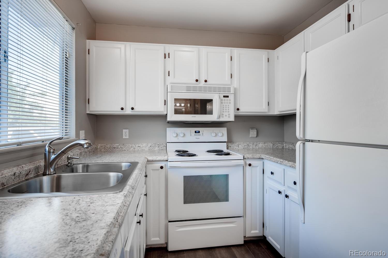 862 Summer Drive Highlands Ranch, CO 80126 - Photo 3 of 21 a kitchen with appliances a sink and cabinets