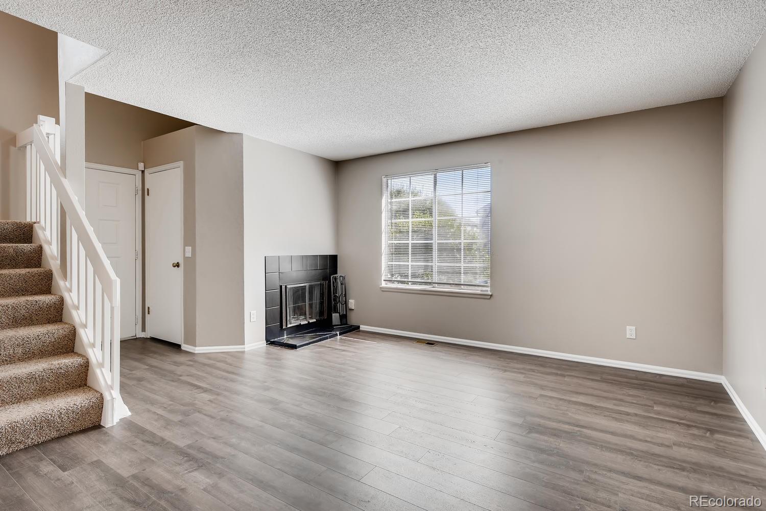 862 Summer Drive Highlands Ranch, CO 80126 - Photo 4 of 21 wooden floor in an empty room with a fireplace