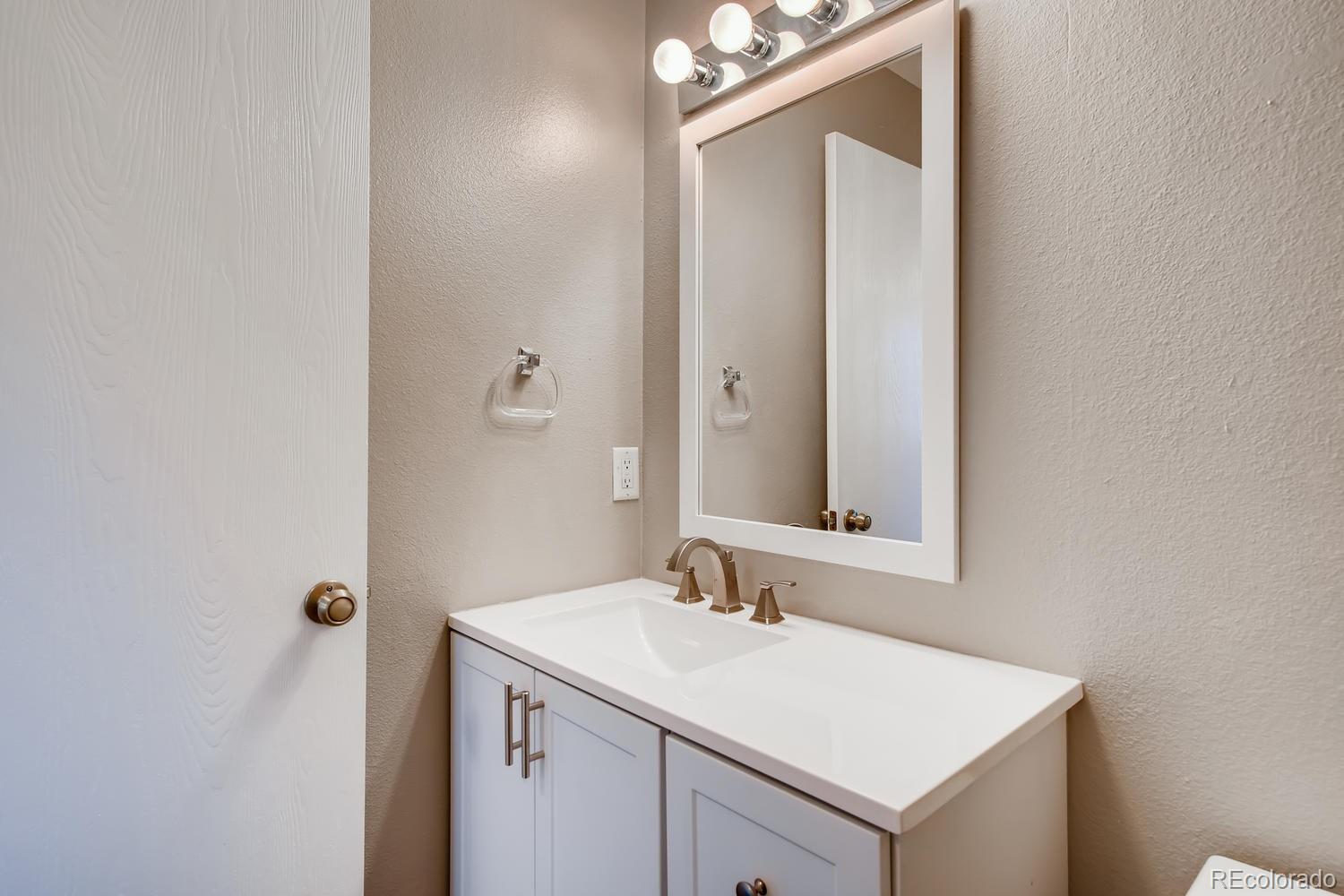 862 Summer Drive Highlands Ranch, CO 80126 - Photo 10 of 21 a bathroom with a sink vanity and a mirror