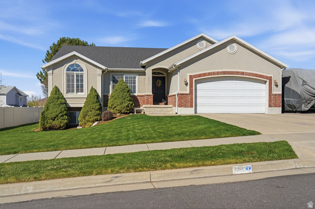 2311 North 10 West Layton, UT 84041 - Photo 1 of 1 Ranch-style house with a garage, driveway, brick siding, and stucco siding