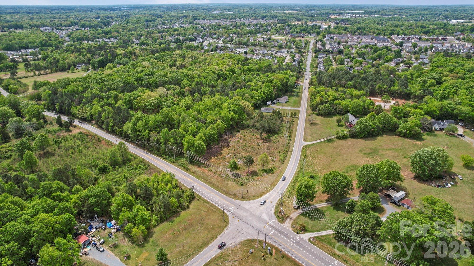 0 Faith Church Road Indian Trail, NC 28079 - Photo 12 of 21 an aerial view of residential houses with outdoor space and trees